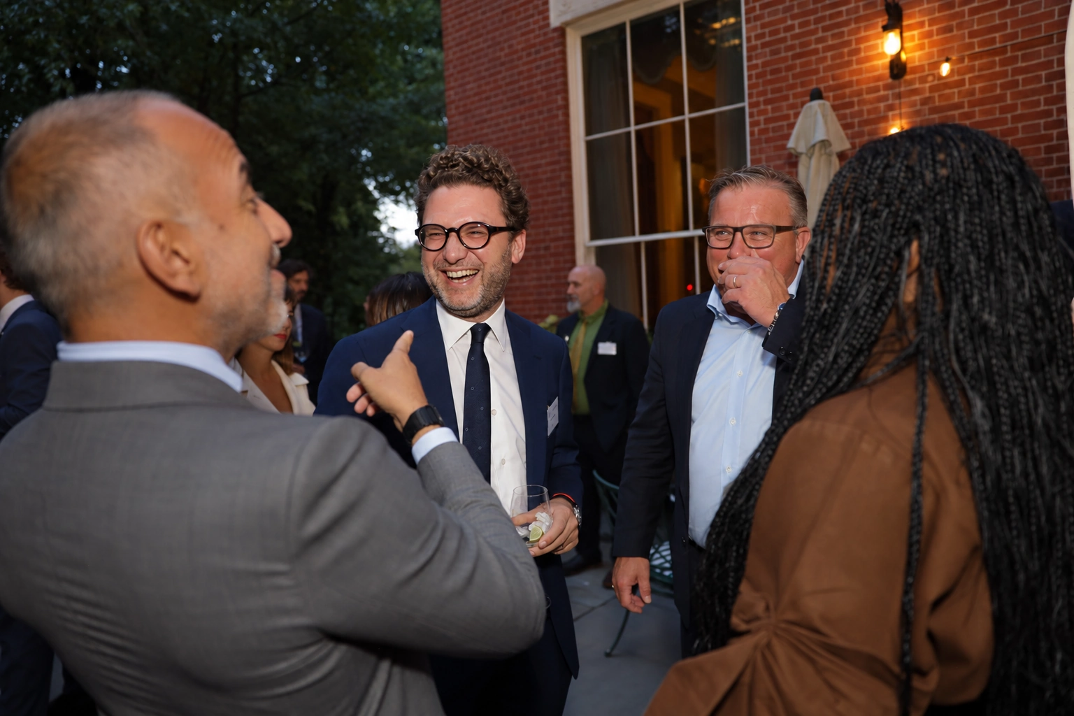 Guests in conversation at an evening networking reception