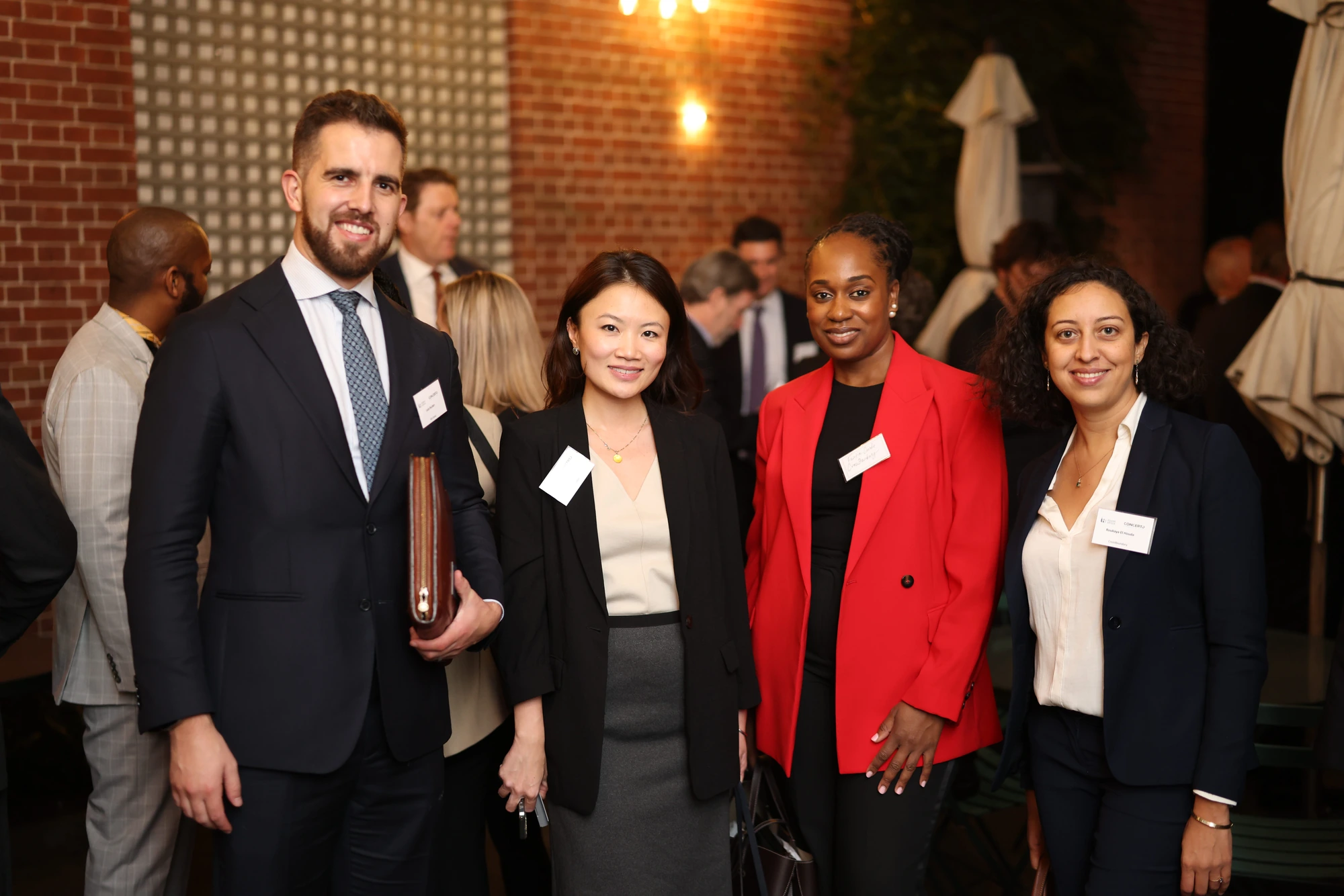 Four guests posing together at a business reception