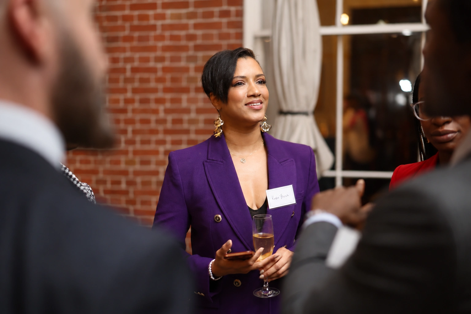 A guest speaking with colleagues at a reception