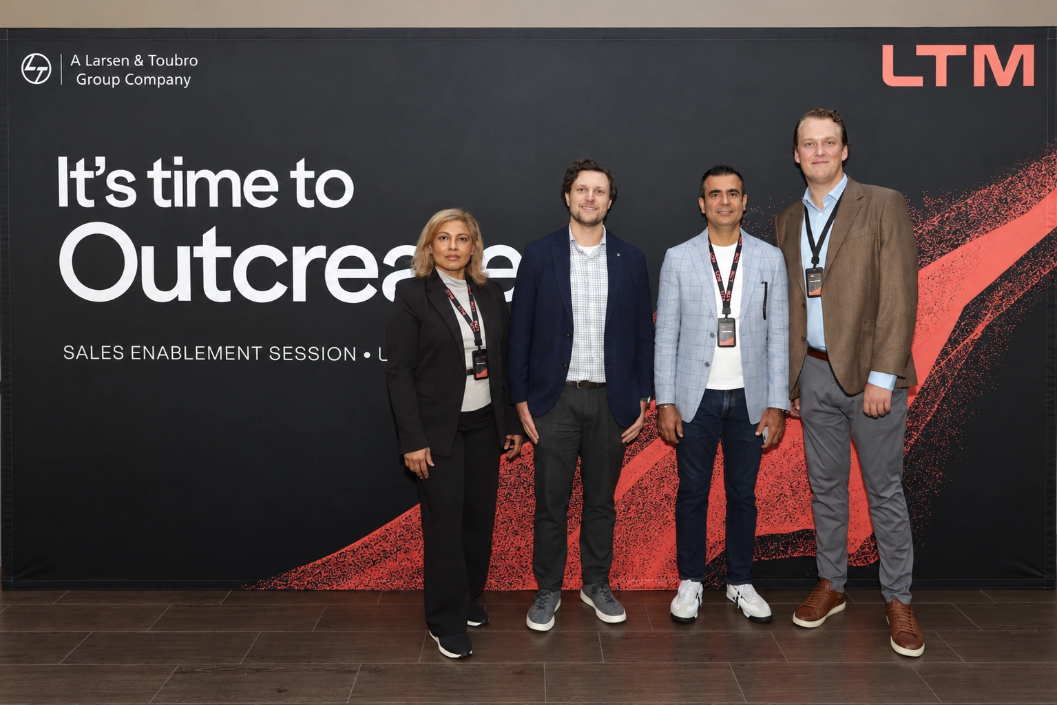 Four attendees at an LTM event backdrop