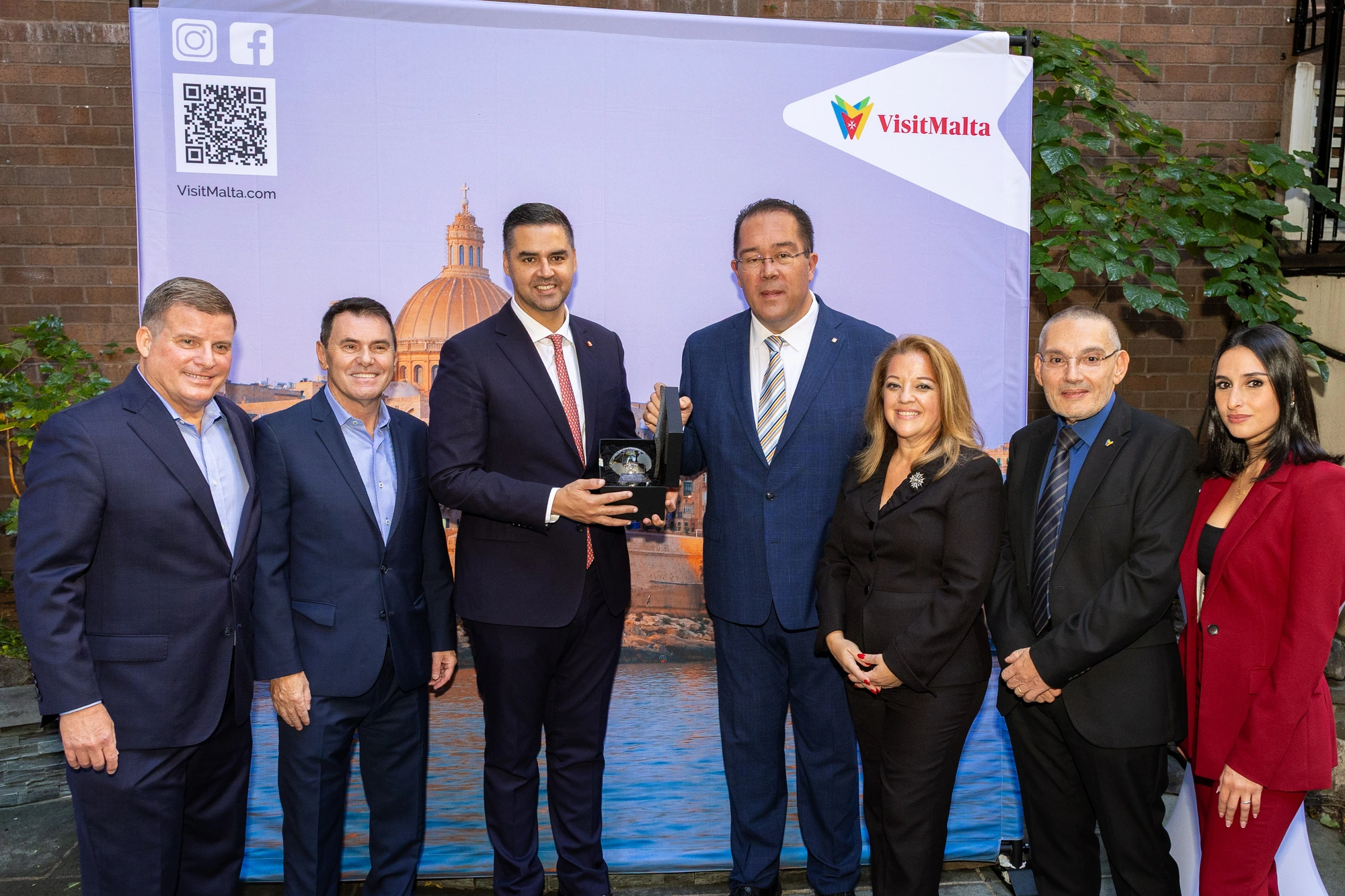 Group photograph at a VisitMalta event backdrop