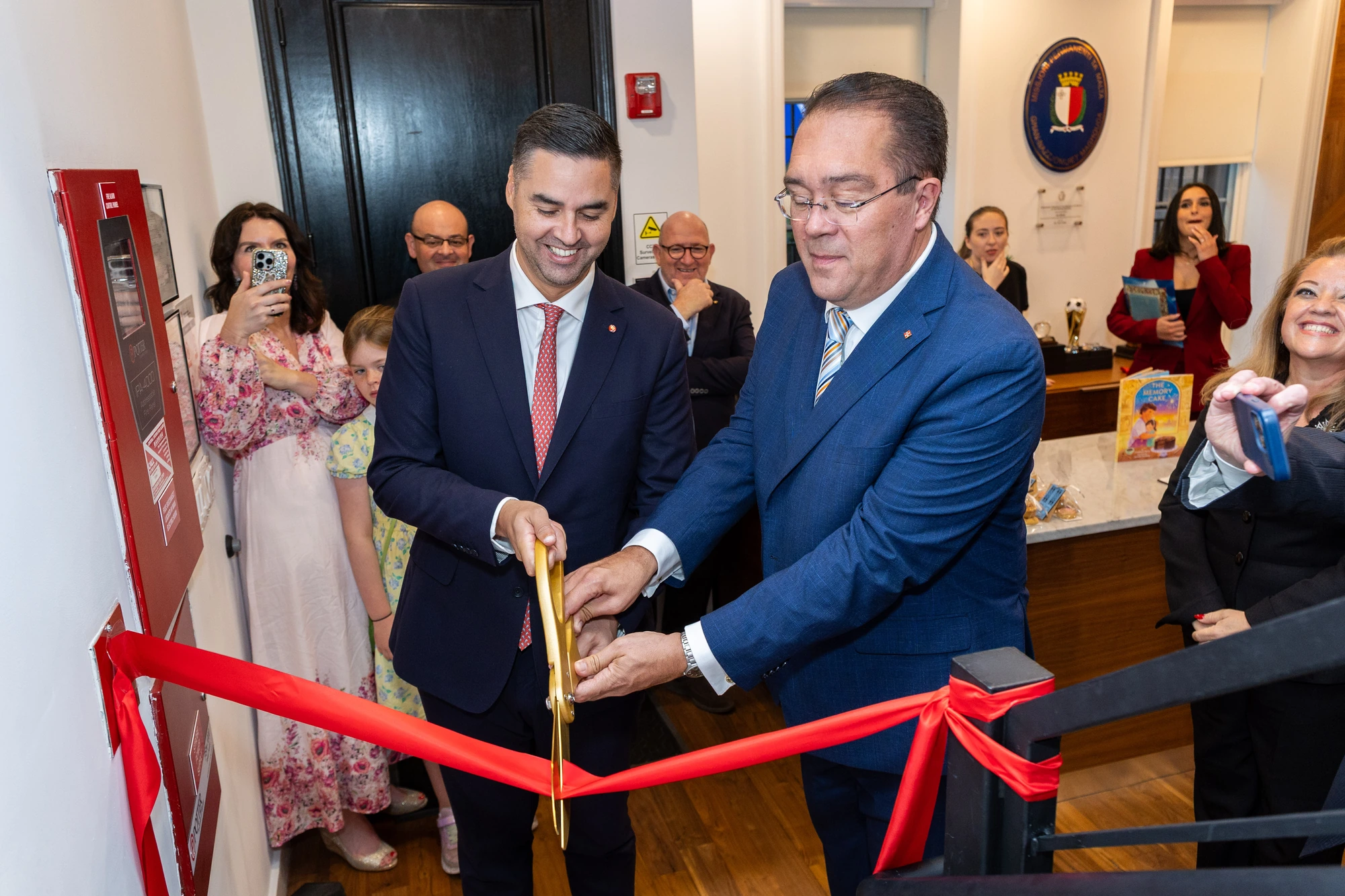 A ceremonial ribbon cutting at an opening event