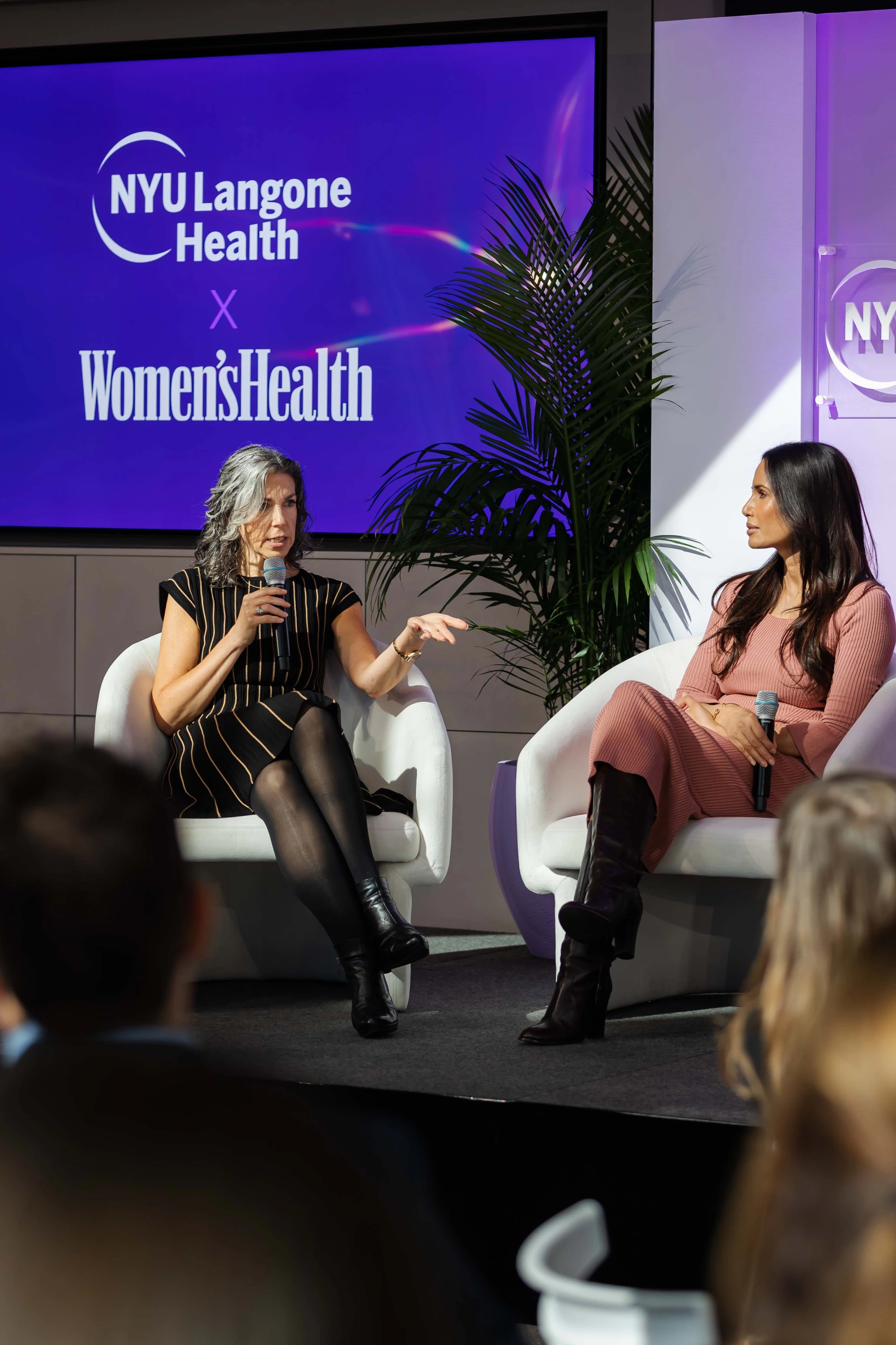 Two panelists with microphones at an NYU Langone Health event