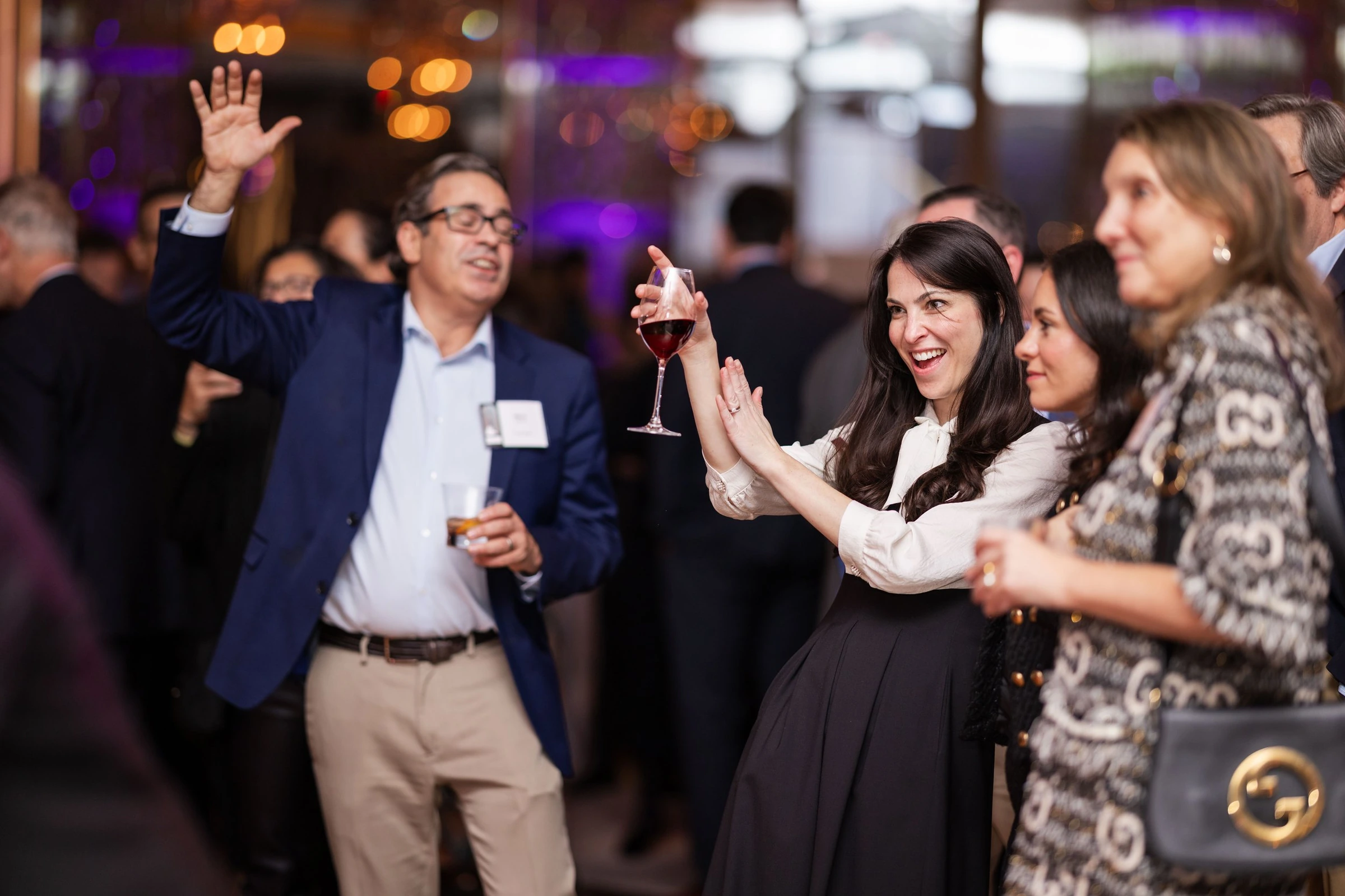 Guests applauding and celebrating at an evening reception