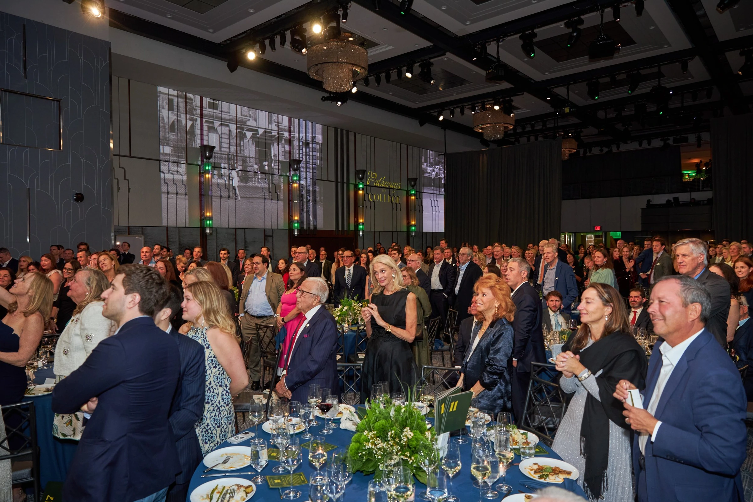 An audience applauding at a formal seated event