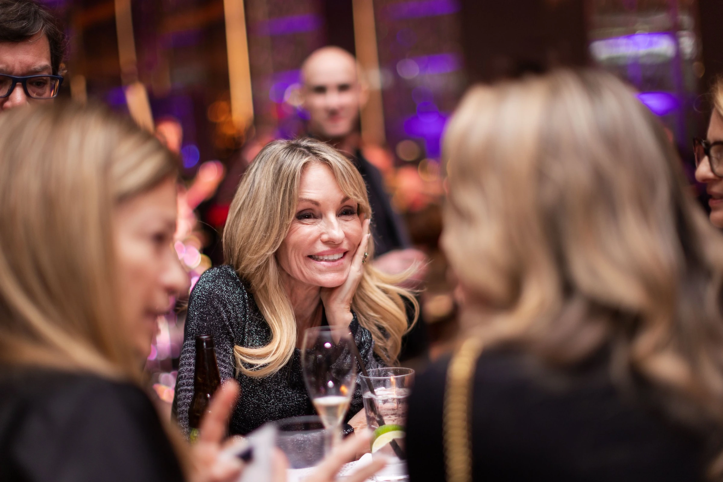 A guest enjoying a conversation at an evening reception