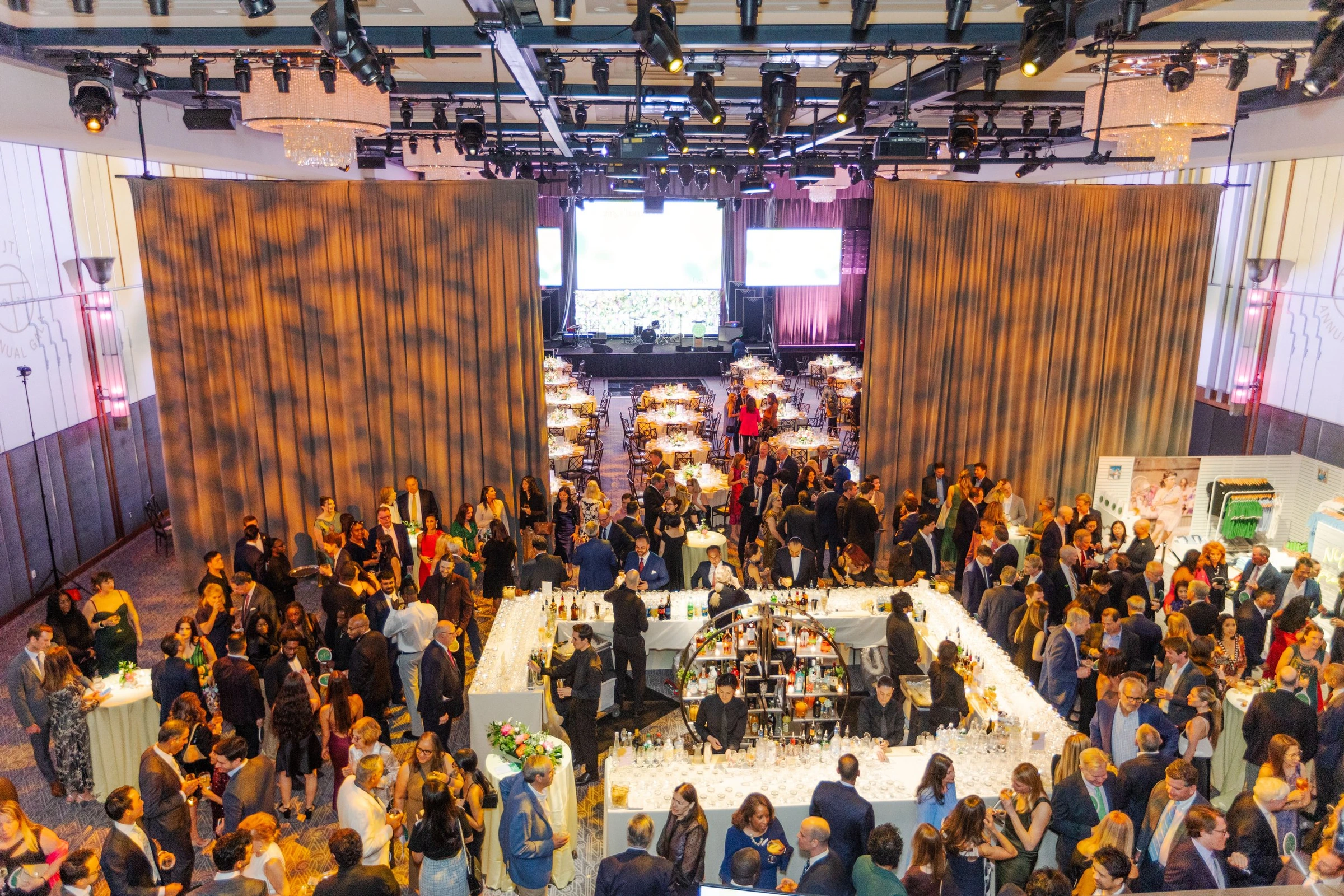 An overhead view of guests and tables during a gala fundraiser
