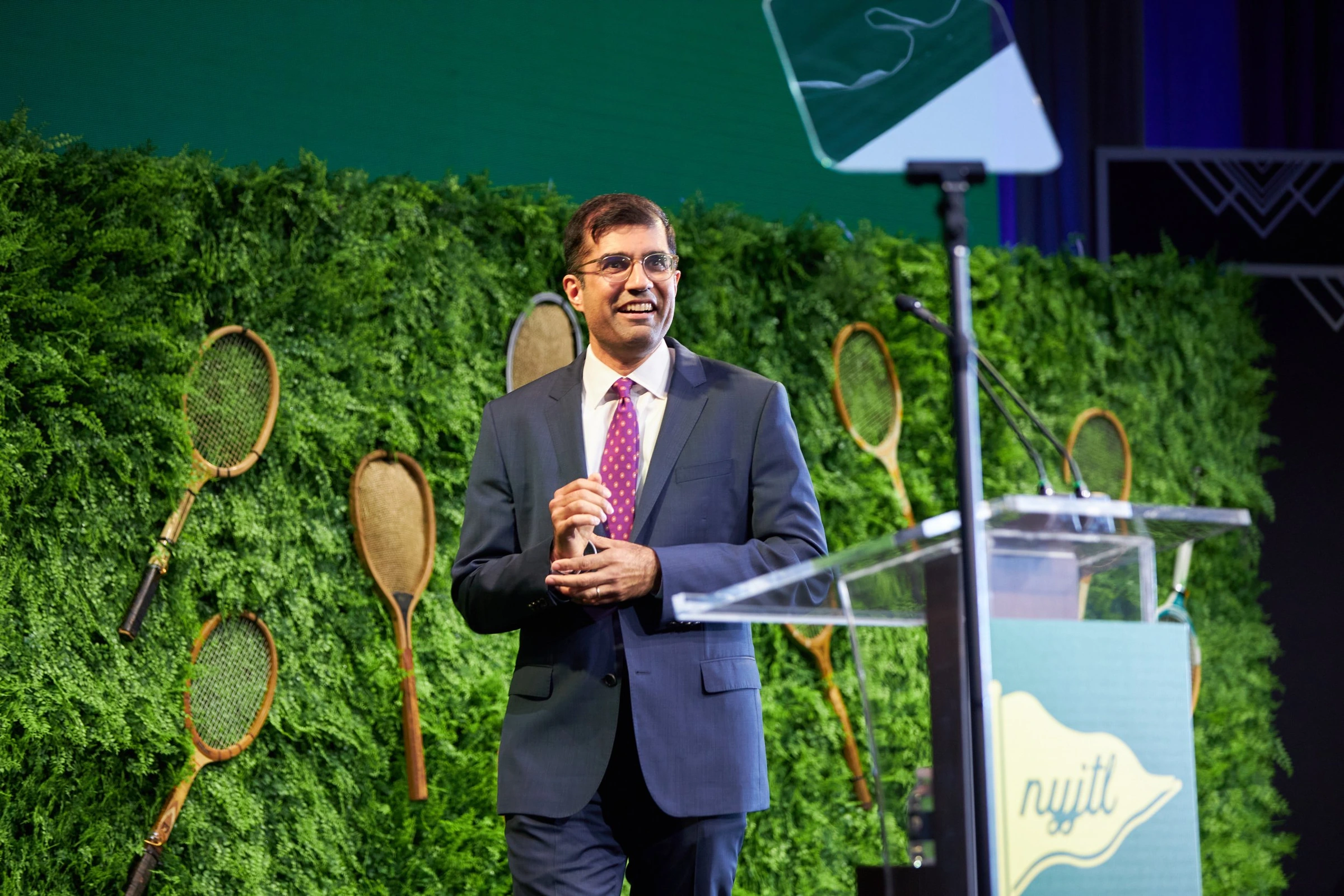 A speaker addressing the audience at a NYJTL event