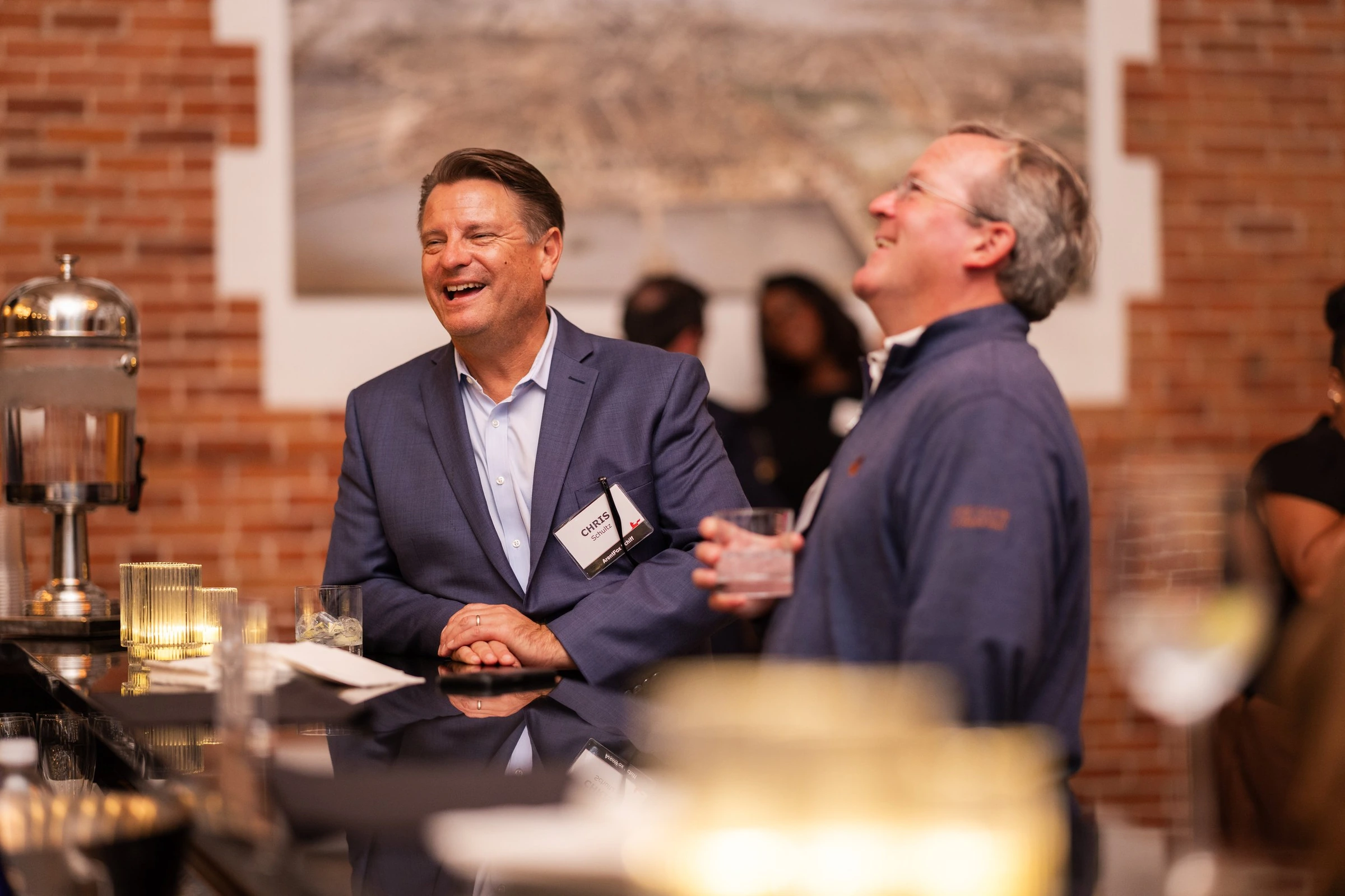 Guests sharing a laugh at a company event