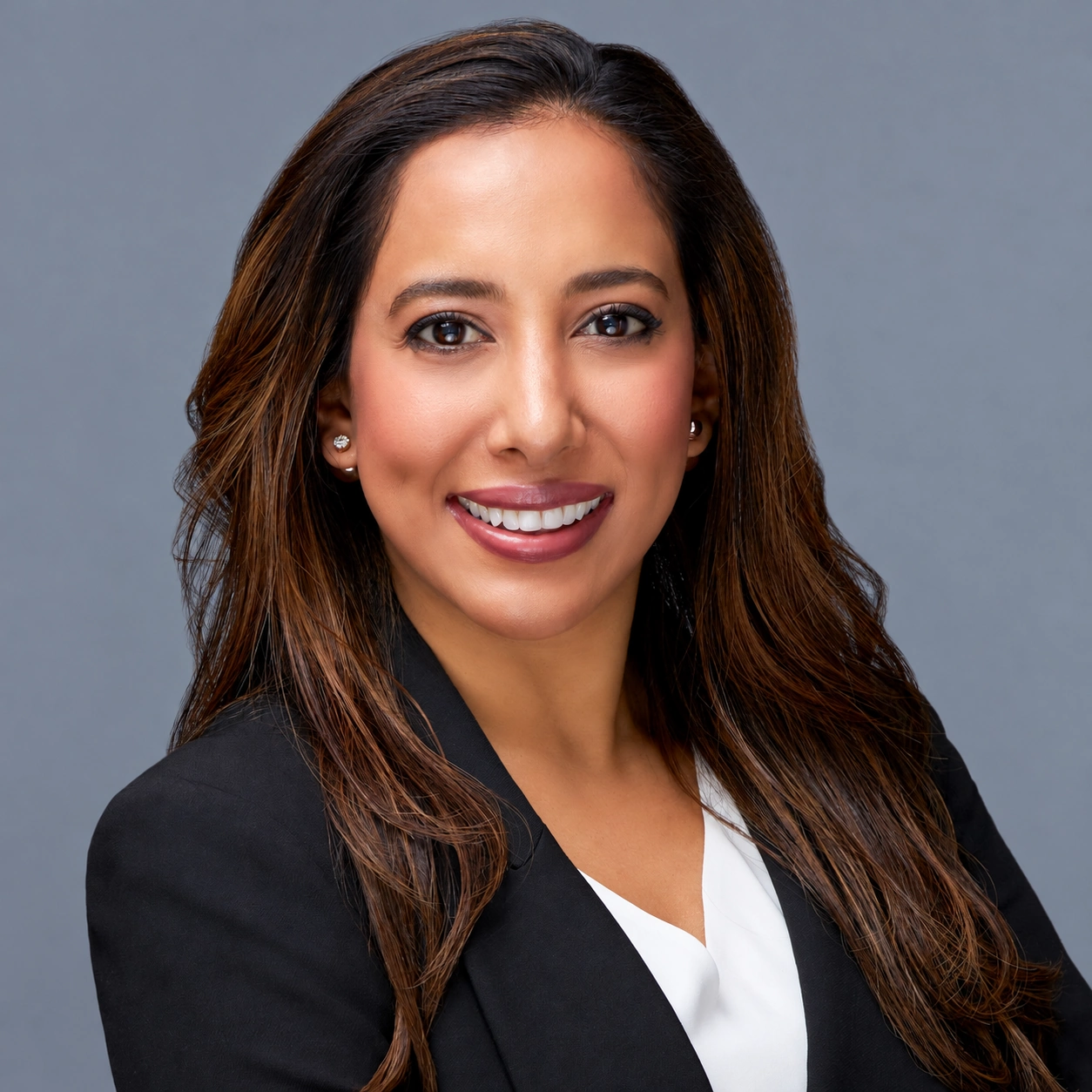 Professional headshot in a black blazer and white blouse