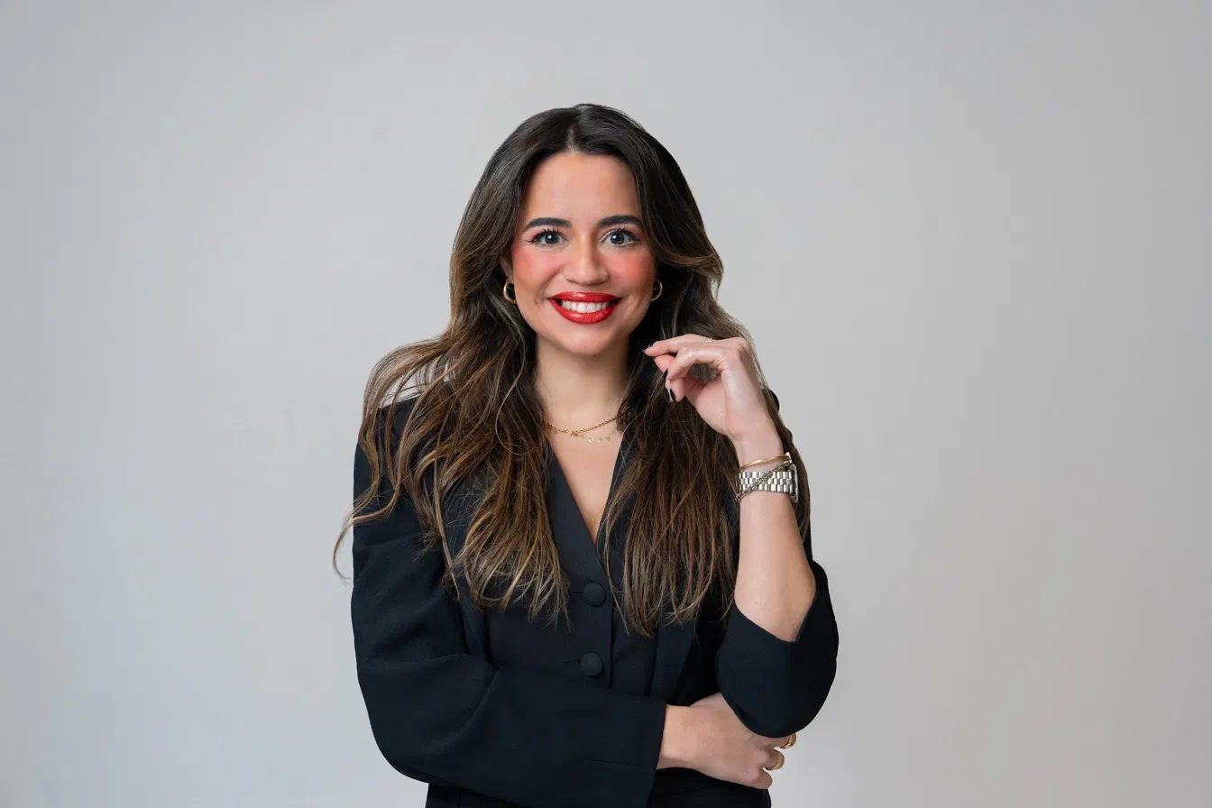 Professional portrait with a bright smile and black blazer